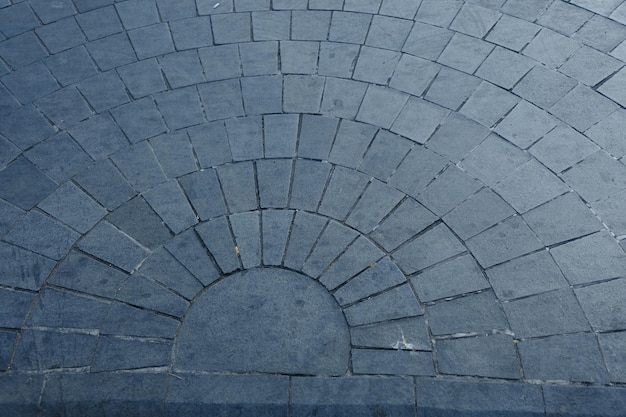 Un pavimento in pietra blu con un motivo circolare al centro.