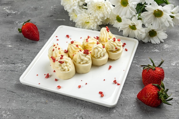 Un piatto di fragole e panna con sopra una fragola