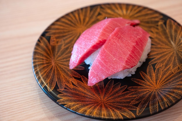 Un piatto di sushi con sopra un disegno a foglia