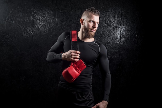 Un pugile che tiene i suoi bagliori su sholder dopo l'allenamento in palestra