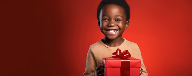 Un ragazzino africano sta aprendo un regalo e ride sullo sfondo rosso Banner copia spazio Generative ai