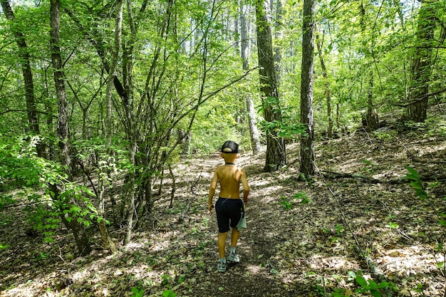 Un ragazzino nella foresta vicino alla città rupestre di TepeKermen Crimea Russia 2021