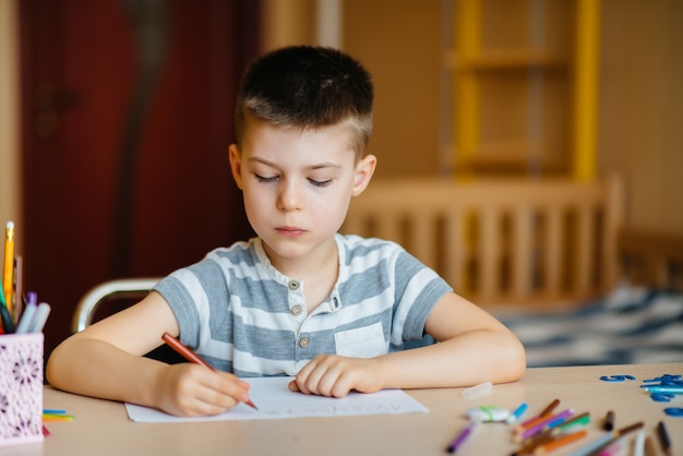 Un ragazzo in età scolare fa i compiti a casa.