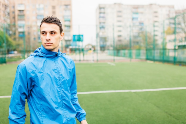 Un ragazzo va per sport, ritratto, bel ragazzo in abbigliamento sportivo. Il ragazzo lavora all'aria aperta, fresca.