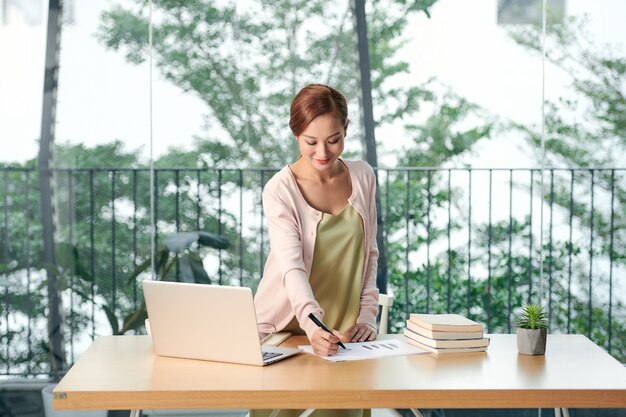 Un ritratto di una bella donna d'affari asiatica con un laptop