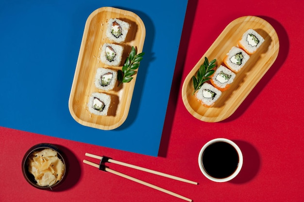 Un tavolo rosso e blu con sushi e bacchette