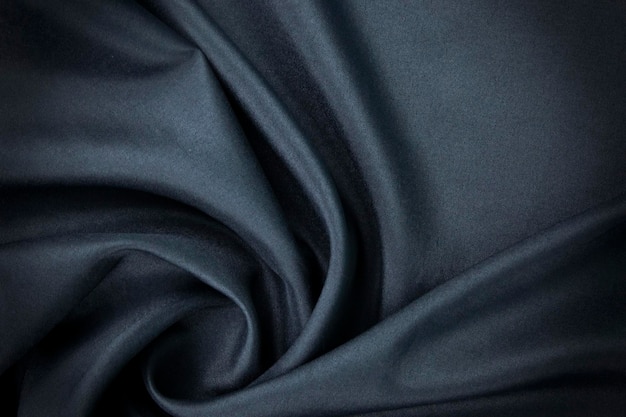 Un tessuto blu scuro vestiti carta da parati tessile concetti di moda di seta e cotone tessuto modello di sfondo tessuto di seta blu tessuto di seta blu drappeggio e tappezzeria