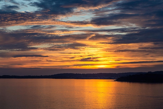 Un tramonto sul mare con un cielo nuvoloso