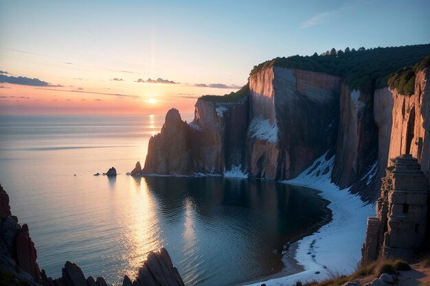 Un tramonto sull'oceano con una scogliera rocciosa in primo piano