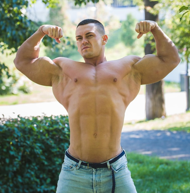 Un uomo con un bel corpo gonfio in posa e mostra i suoi muscoli