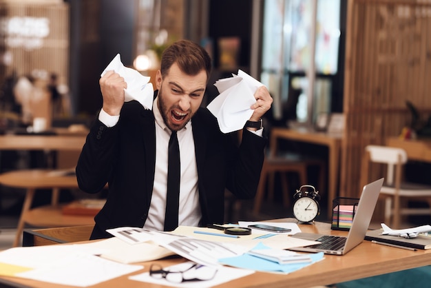 Un uomo è deluso dalla grande quantità di lavoro.