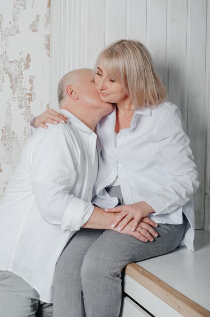 un uomo e sua moglie in camicie bianche in uno studio fotografico