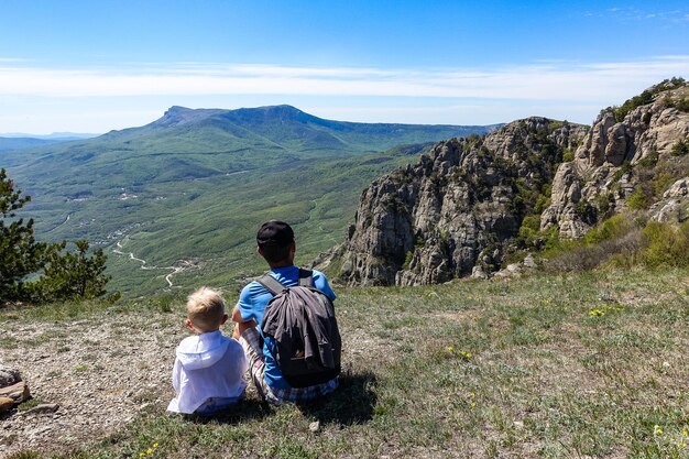 Un uomo e un ragazzo sullo sfondo una vista dell'altopiano di ChatyrDag Russia