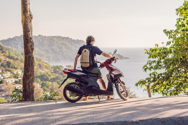 Un uomo in moto contro il mare.