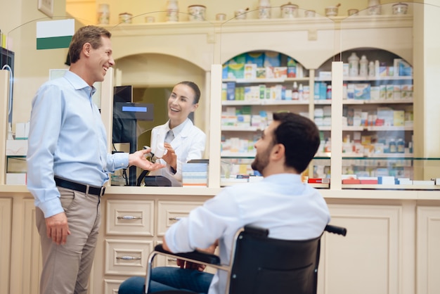 Un uomo su una sedia a rotelle è in una farmacia.