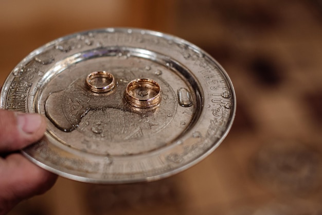 Un vassoio d'argento con fedi nuziali in chiesa