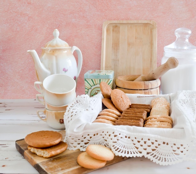 Un vassoio di biscotti su un tavolo di legno bianco e uno sfondo rosa