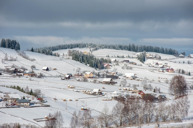 Un villaggio alpino in Transilvania, in Romania, con le case coperte di neve in inverno