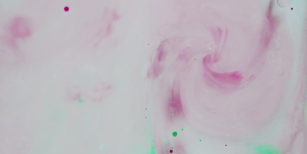 Un vortice rosa e verde con sopra la scritta ink.