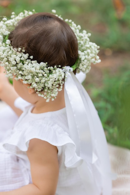 una bambina con una corona di fiori in testa