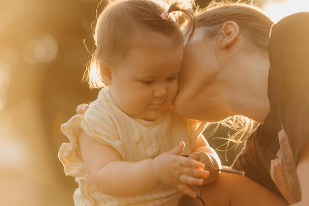 Una bambina in abiti gialli sta giocando con gli occhiali da sole nel parco