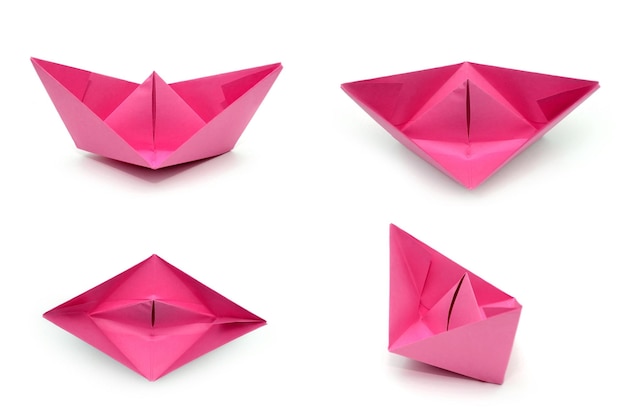 Una barca di origami di carta rosa brillante Una vista da più lati