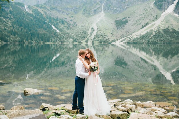 Una bella giovane coppia al lago nei monti Tatra in Polonia Morskie Oko