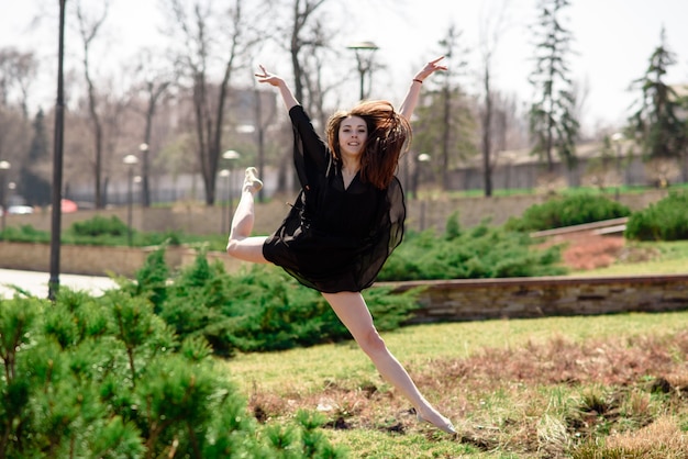 Una bella ragazza è impegnata nella coreografia nella natura