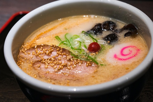 Una ciotola di ramen con una striscia rossa sul lato.