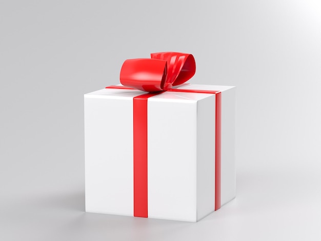 Una confezione regalo bianca con un nastro rosso e un fiocco sopra.