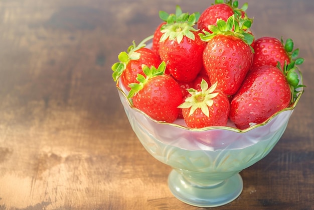 Una delicata tazza contiene un'abbondanza di fresche fragole deliziose