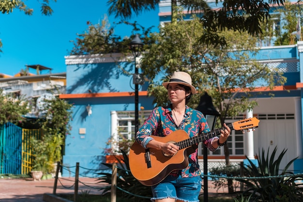 Una donna che suona la chitarra all'aperto