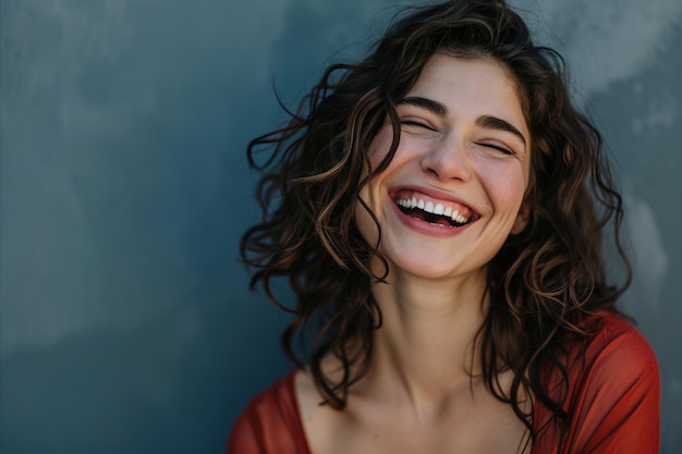 Una donna con i capelli ricci che ride e sorride