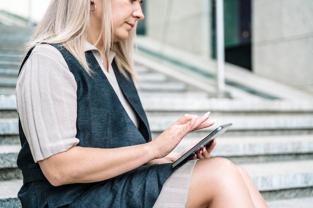 Una donna d'affari con un tablet lavora con dati finanziari nel business della città d tecnologia
