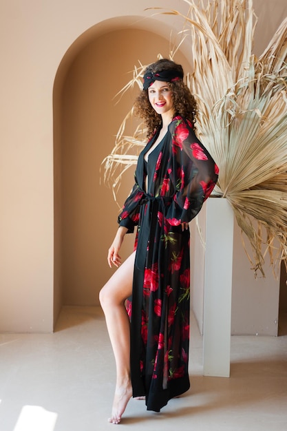 Una donna in kimono nero con un fiore rosso sul davanti