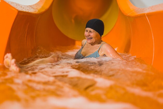 Una donna si diverte su uno scivolo d'acqua.