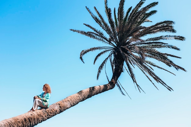 Una donna turista seduta su una palma in viaggio tropicale estate vacanza destinazione di vacanza Donne che si rilassano in un fantastico parco panoramico Stile di vita turistico Ragazza attività per il tempo libero all'aperto