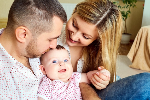 Una famiglia felice. Mamma e papà con bambino in camera