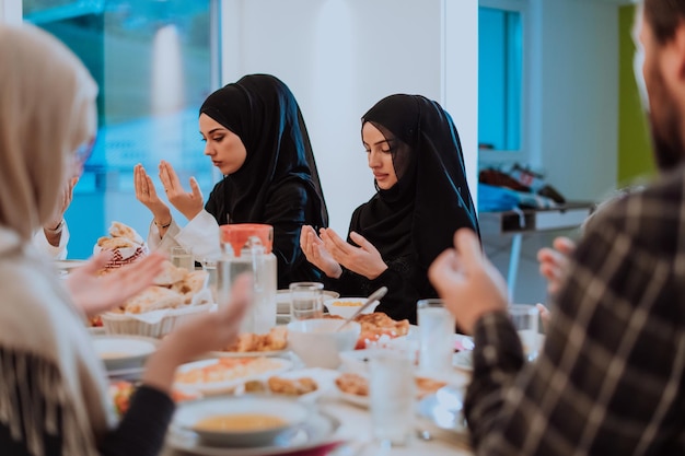 Una famiglia musulmana che prega insieme, la preghiera musulmana dopo aver rotto il digiuno nel mese sacro islamico del Ramadan.