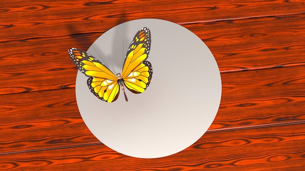 Una farfalla gialla si siede su un tavolo di legno