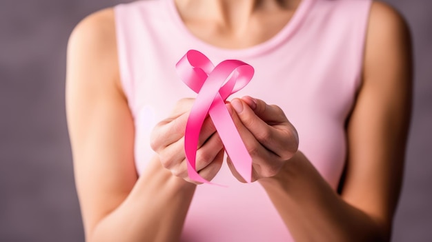 Una foto in primo piano di un nastro rosa tenuto nelle mani di una donna