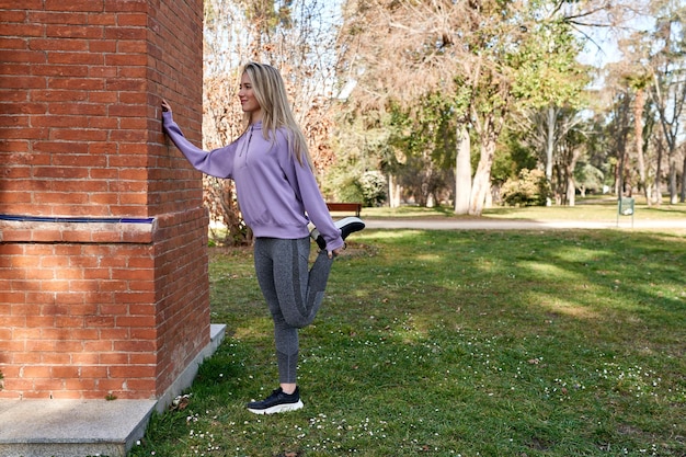 Una giovane donna caucasica che si estende per un inizio sano