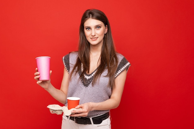 Una giovane donna che tiene in mano un caffè da asporto