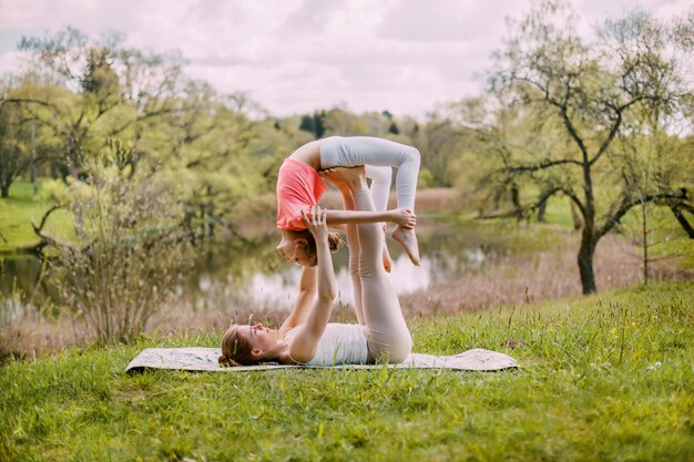 Una giovane madre pratica yoga con sua figlia.