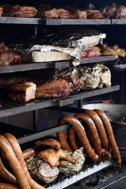 Una grande griglia viene utilizzata per cuocere diversi tipi di carne e verdure Street Food Festival