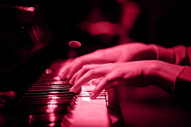 Una mano maschile sul pianoforte Un classico fresco per il 2023 nel concetto Viva Magenta Color of the year