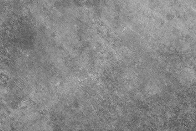 Una parete strutturata grigia con uno sfondo grigio scuro.