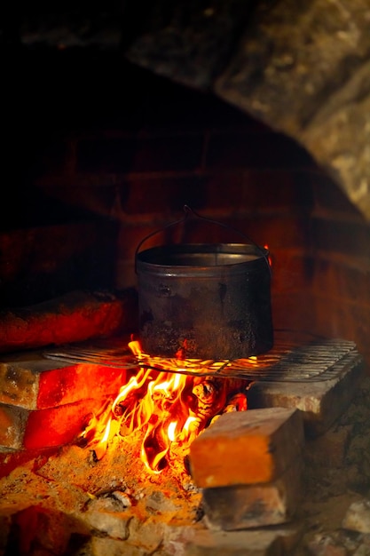 Una pentola sul fuoco in un forno di mattoni