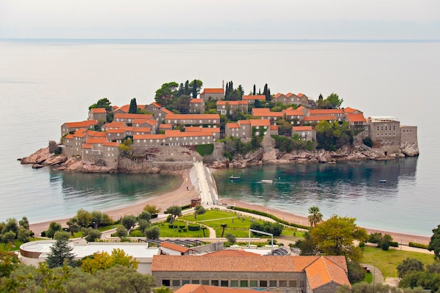 Una piccola isola con un ponte e una cittadina in lontananza.