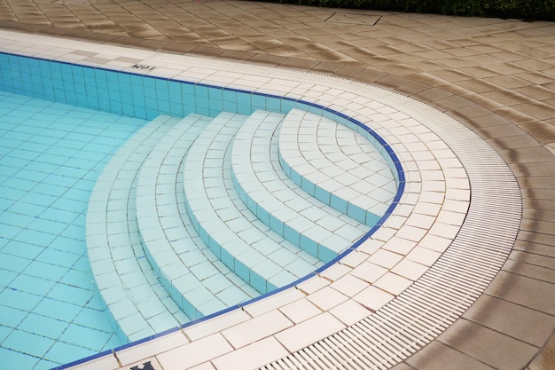 Una piscina vuota con scala a chiocciola